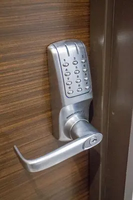 a silver door handle on a wooden door at Sakura Cross Hotel Shinjuku East in Tokyo