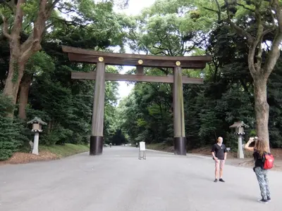 two people standing in front of a torii gate at Sakura Cross Hotel Shinjuku East in Tokyo