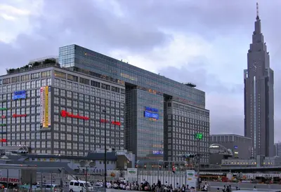 a large building with people standing in front of it at Sakura Cross Hotel Shinjuku East in Tokyo