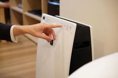 a hand is pushing a button on a computer monitor at karaksa hotel TOKYO STATION in Tokyo