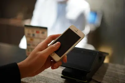 a person holding a cell phone in their hand at karaksa hotel TOKYO STATION in Tokyo