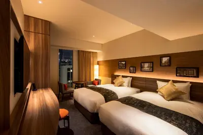 a hotel room with two beds and a television at karaksa hotel premier Tokyo Ginza in Tokyo