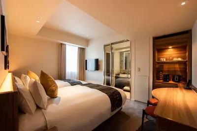 a hotel room with a bed and a television at karaksa hotel premier Tokyo Ginza in Tokyo