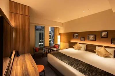 a hotel room with a bed and a table at karaksa hotel premier Tokyo Ginza in Tokyo