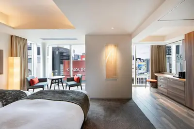 a hotel room with two beds and a balcony at karaksa hotel premier Tokyo Ginza in Tokyo