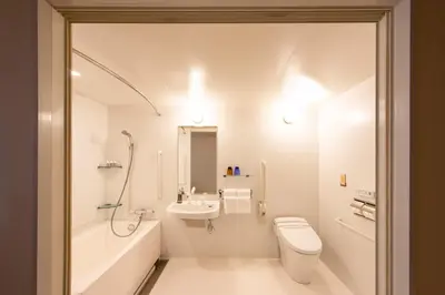a white bathroom with a toilet and a sink at karaksa hotel premier Tokyo Ginza in Tokyo