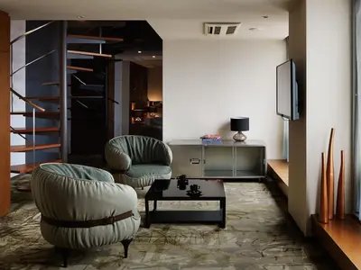 a living room with two chairs and a tv at Akasaka Granbell Hotel in Tokyo