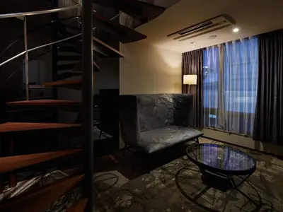 a room with a couch and a chair and a glass table at Akasaka Granbell Hotel in Tokyo