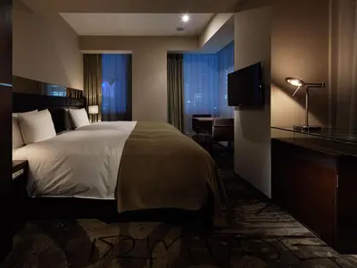 a bedroom with a bed and a desk and a television at Akasaka Granbell Hotel in Tokyo