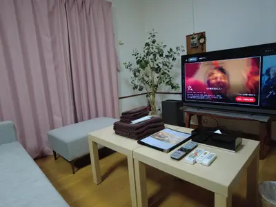 a living room with a tv and a coffee table at Yahiro Skytree House in Tokyo