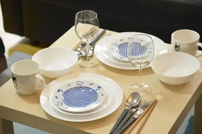 a table with plates and cups and wine glasses at Yahiro Skytree House in Tokyo