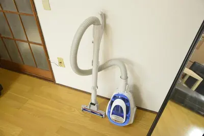 a vacuum cleaner leaning against a wall at Yahiro Skytree House in Tokyo
