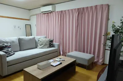 a living room with a couch and a coffee table at Yahiro Skytree House in Tokyo
