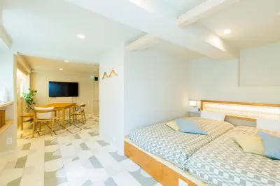 a bedroom with a bed and a dining room at KAGO 34 Tokyo by Shukuba HOTEL in Tokyo