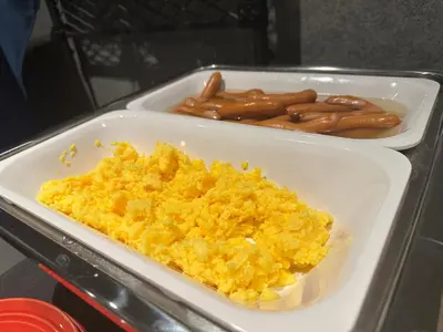 two styrofoam containers of scrambled eggs and hot dogs at HOTEL SUI AKASAKA by ABEST in Tokyo
