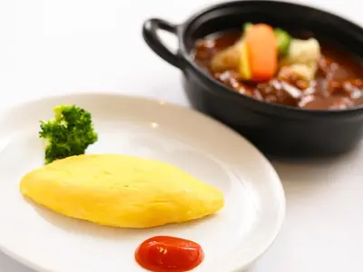 a plate of food with broccoli and a bowl of soup at Dormy Inn Premium Shibuya-jingumae in Tokyo