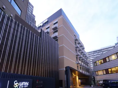 a tall building in a city with tall buildings at Dormy Inn Premium Shibuya-jingumae in Tokyo