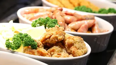 a group of bowls of food with broccoli and other foods at Dormy Inn Premium Shibuya-jingumae in Tokyo