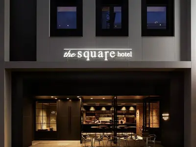 a store front of a square hotel with tables and chairs at the square hotel GINZA in Tokyo