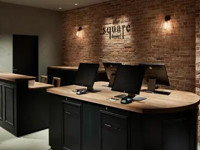 a counter with three computer monitors on top of it at the square hotel GINZA in Tokyo