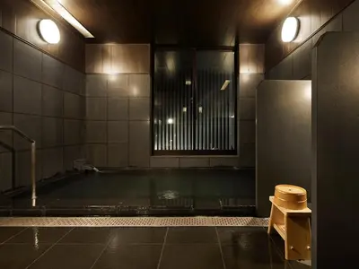 a bathroom with a bath tub with a shower at the square hotel GINZA in Tokyo