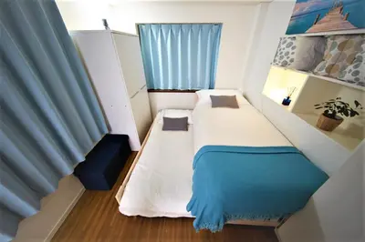 a small room with two beds and a window at SHINJUKU 5-ROOM Family house in Tokyo