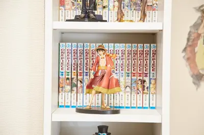 a toy figure on a shelf with books at SHINJUKU 5-ROOM Family house in Tokyo