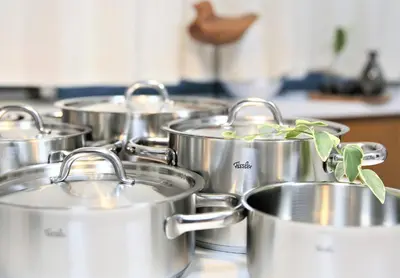 a group of silver pots sitting on a stove at SHINJUKU 5-ROOM Family house in Tokyo