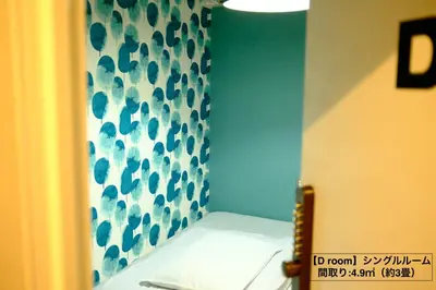 a bathroom with a blue and white shower curtain at COZY INN Tokyo Sakura Town in Tokyo