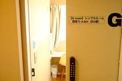 a door with a sign on it next to a room at COZY INN Tokyo Sakura Town in Tokyo