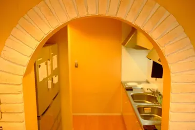 an archway in a kitchen with an orange wall at COZY INN Tokyo Sakura Town in Tokyo