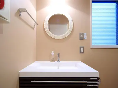 a bathroom with a white sink and a mirror at COZY INN Tokyo Sakura Town in Tokyo
