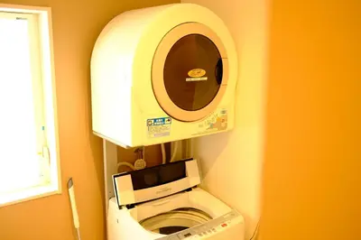 a machine in a bathroom with a toilet at COZY INN Tokyo Sakura Town in Tokyo