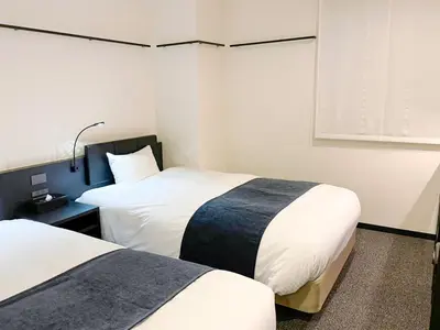 a hotel room with two beds and a window at HOTEL SUI KANDA by ABEST in Tokyo