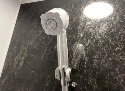 a shower in a bathroom with a black counter top at HOTEL SUI KANDA by ABEST in Tokyo