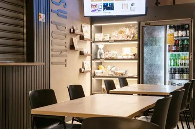 a restaurant with tables and chairs and a bar at ICI HOTEL Asakusabashi in Tokyo