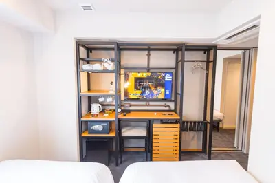 a room with a tv and a desk in a room at ICI HOTEL Asakusabashi in Tokyo