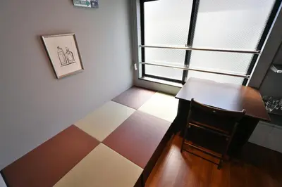 a small room with a table and a window at Stylewood Sangenjaya by Tranova in Tokyo