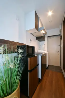 a kitchen with a black refrigerator and a sink at Stylewood Sangenjaya by Tranova in Tokyo