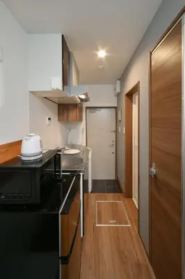 a kitchen with a sink and a microwave at Stylewood Sangenjaya by Tranova in Tokyo