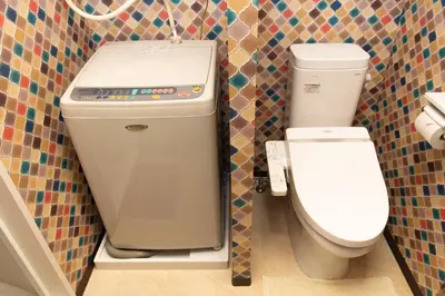a bathroom with a toilet and a sink at Guest House One More Heart at TSUKIJI 1 in Tokyo