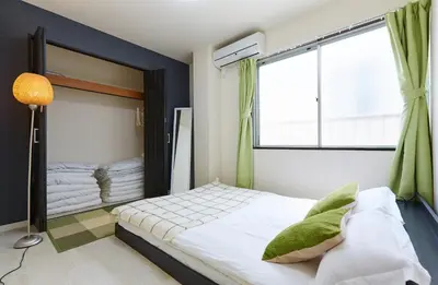 a bedroom with a bed and a large window at H-Nishikamata ColorBee House in Tokyo