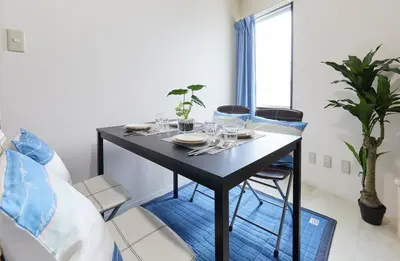 a table with plates and glasses on it in a room at H-Nishikamata ColorBee House in Tokyo