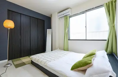 a small bedroom with a bed and a window at H-Nishikamata ColorBee House in Tokyo