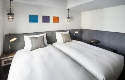 two beds sitting next to each other in a room at Hotel Resol Akihabara in Tokyo