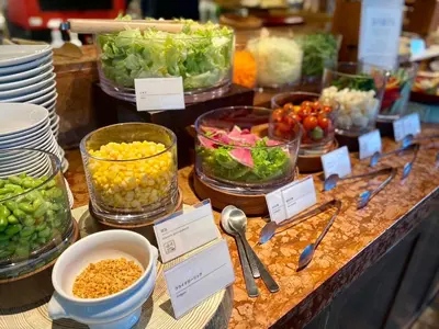a buffet with bowls of vegetables and bowls of food at Hotel Resol Akihabara in Tokyo