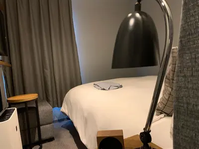 a room with a bed and a black lamp at Hotel Resol Akihabara in Tokyo