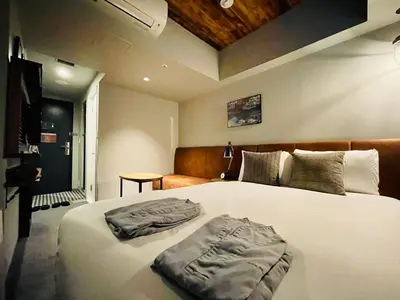 a bedroom with a large white bed in a room at Hotel Resol Akihabara in Tokyo