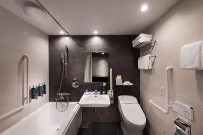 a bathroom with a sink and a toilet at DoubleTree by Hilton Tokyo Ariake in Tokyo