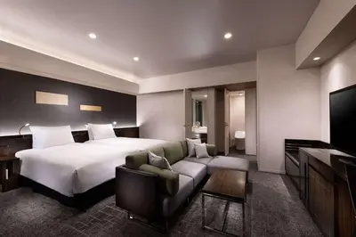 a hotel room with a large bed and a couch at DoubleTree by Hilton Tokyo Ariake in Tokyo
